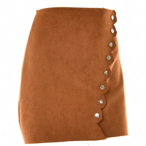 Detail view of brown faux suede mini skirt featuring scalloped hem and silver button accents