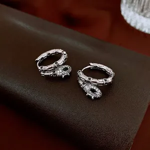 Elegant silver snake hoop earrings with white zircon paving and black gemstone accents