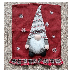 Detail of red linen Christmas gnome chair cover with 3D beard and snowflake accents