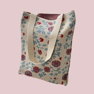 Detail of the high-quality knitted floral tote bag with blue and red patterns and texture