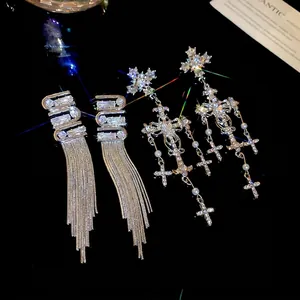 Luxury silver long fringe earrings with crystals and pearl cross pendants on black background