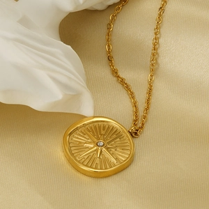 18k gold plated stainless steel necklace with sparkling starburst compass pendant