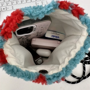 Detailed interior view of plush rainbow polka dot bag showing capacity for daily essentials
