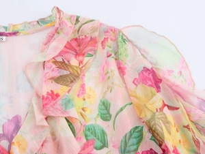 Detail of pink floral poplin shirt showing ruffle neckline and delicate stitching quality