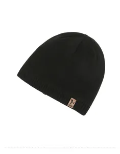 Detail shot of a black knitted beanie featuring a brown leather patch and ribbed cuff texture