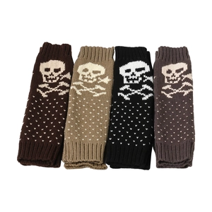 Knitted fingerless gloves with white skull patterns in black, brown, beige, and grey