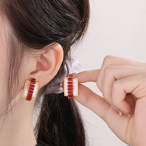 Elegant gold rectangular earrings with red baguette crystals and white pearl backing