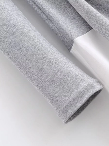 Detailed macro view of the grey marl fabric and white stitching on a bow-knot dress