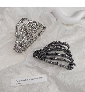 Detailed view of gothic skull hand hair claws in silver and gun-black alloy metal