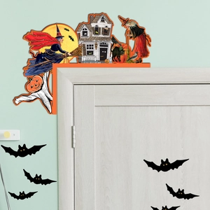 Detail of Halloween door corner decor with wooden witch on broom and spooky bat stickers
