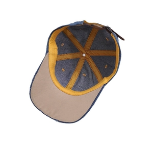 Interior view of vintage denim baseball cap with mustard sweatband and leather strap