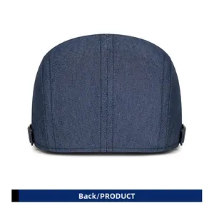 Rear view of denim flat cap showing metal side buckles and twill fabric texture