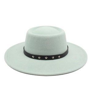 Detail of mint green wool felt hat with black leather strap and silver star rivets