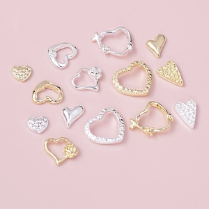 Exquisite gold and silver heart-shaped nail art charms with zircon and floral details