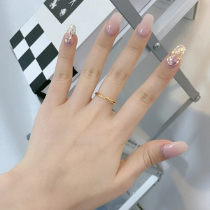 Minimalist S925 sterling silver gold twisted open ring shown on a hand with manicure