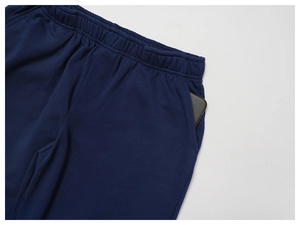 Detail of high waist sweatpants showing deep side pocket with a smartphone inside