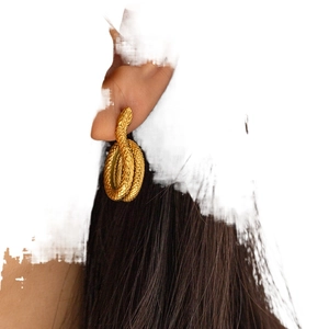 Snake shape 18K gold plated stainless steel earrings shown on model ear profile