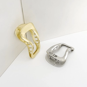 Irregular geometric hollow metal hair clips in gold and silver finish on white background