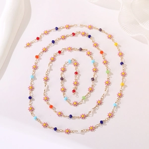 Spiral layout of colorful daisy bead necklace with gold chain and enamel flowers