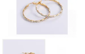 Close-up of wavy 18K gold plated hoop earrings with shimmering white cubic zirconia
