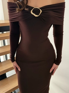 Detail of elegant off-shoulder brown dress with a gold metal ring on the neckline