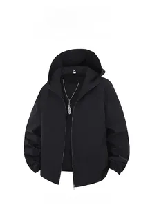 Detail of black hooded jacket with zipper closure and a silver feather pendant necklace