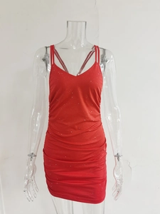 Detail of red sequined mini dress featuring ruching and shimmering silver accents