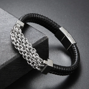 Detail of black woven leather bracelet with silver chain layers and magnetic buckle