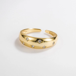 Detail of S925 sterling silver star ring with gold finish and inlaid zircon stones