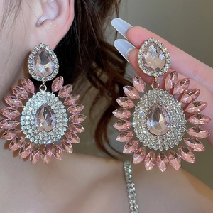 Macro shot of pink crystal waterdrop flower earrings with sparkling rhinestone settings