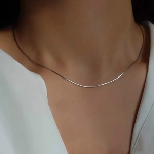 Minimalist silver snake chain necklace for women showing reflective metallic luster