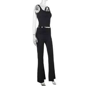 Detail view of black sleeveless top and flared leggings set on transparent mannequin