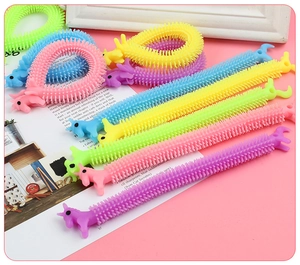 Close-up of colorful TPR unicorn stretchy strings with textured sensory surface