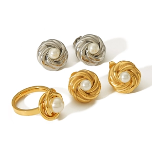 Elegant gold and silver flower knot earrings and ring set with pearls on white background