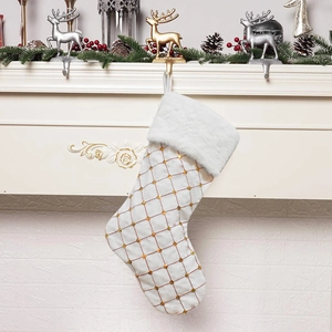 Christmas stocking with gold sequin plaid and white faux fur cuff hung by a fireplace