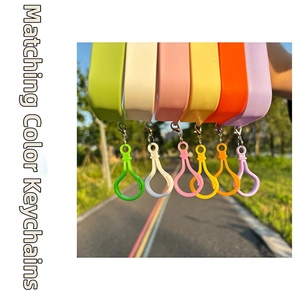 Close-up of colorful macaron plastic spray bottle keychains with metal snap hooks