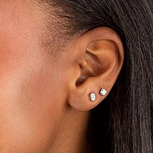 Detailed close-up of 925 silver geometric stud earrings worn on the ear for a bridal look