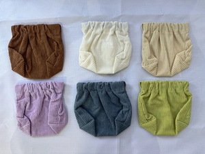 Detail of baby corduroy bloomers in six colors showing elastic waist and soft ribbed texture