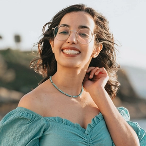 Bohemian style thin turquoise beaded choker necklace on model with golden accents