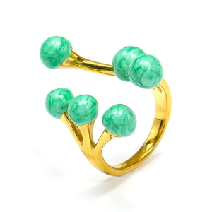 Detail of multi-bead gold ring featuring green marble texture spheres and 18k plating