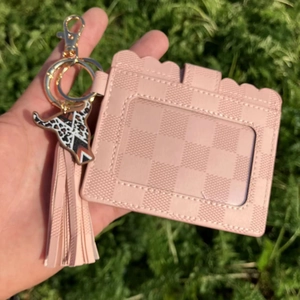 Pink checkered card holder keychain with leather tassel and cow-head pendant detail