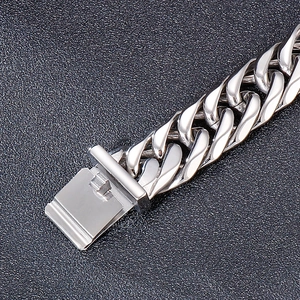 Macro detail of silver stainless steel Cuban link bracelet with secure clasp mechanism