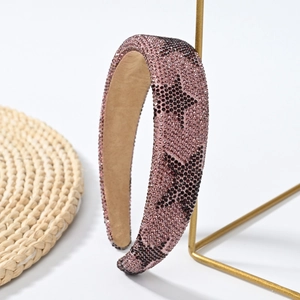 Detailed view of pink-brown wide headband with sparkling rhinestones and star patterns