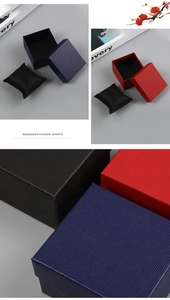 Detail of luxury textured square watch boxes with soft cushions in navy, red and black