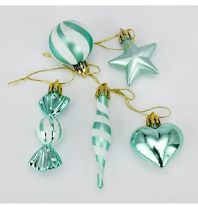 Detail of mint green Christmas ornaments including star, heart, and candy shapes with glitter