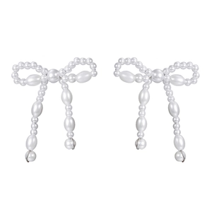 Detailed view of elegant white faux pearl earrings with a dangling bow knot design