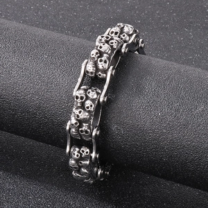 Close-up of vintage silver skull charm on a double-row punk style bicycle chain bracelet