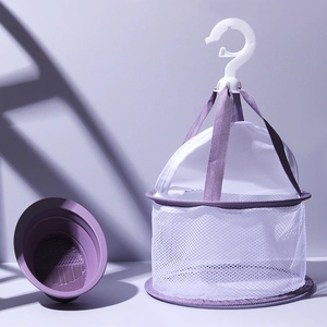 Purple makeup sponge drying mesh bag and silicone brush cleaning pad on studio background