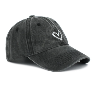 Detail of white heart embroidery on washed cotton fabric of the vintage baseball cap