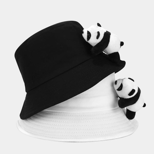 Detail of cute plush panda ornaments on cotton sun hats for children in black and white